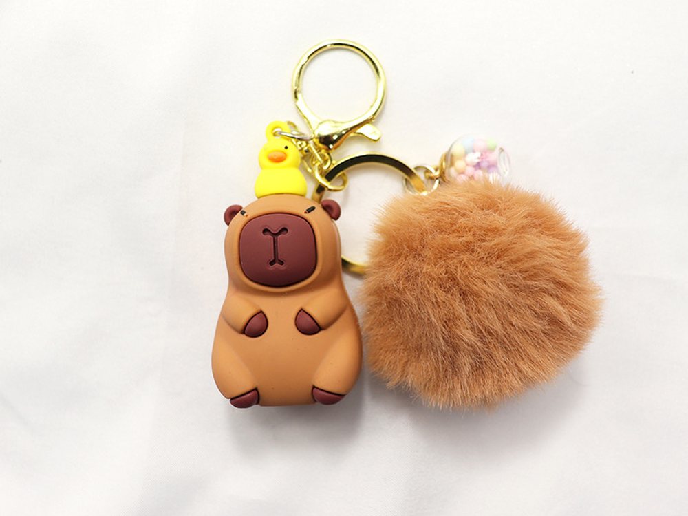 Plush animal bag charm: capybara with a fluffy pom pom on a keyring
