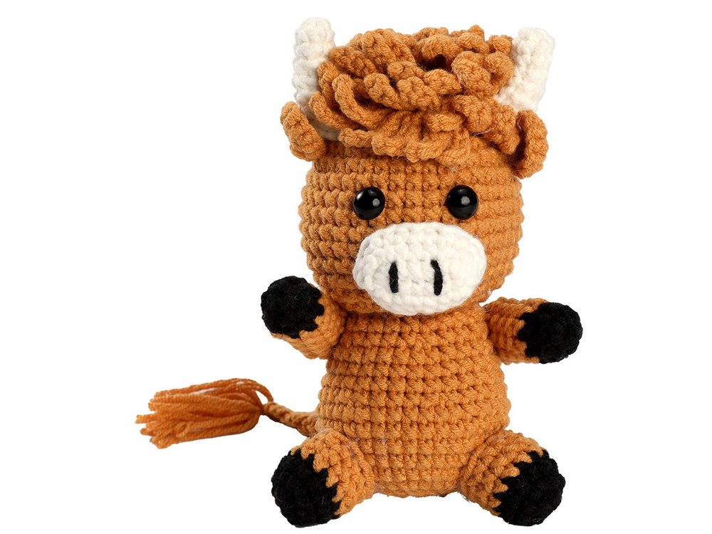 Finished crochet Highland cow, sitting, from the beginner kit