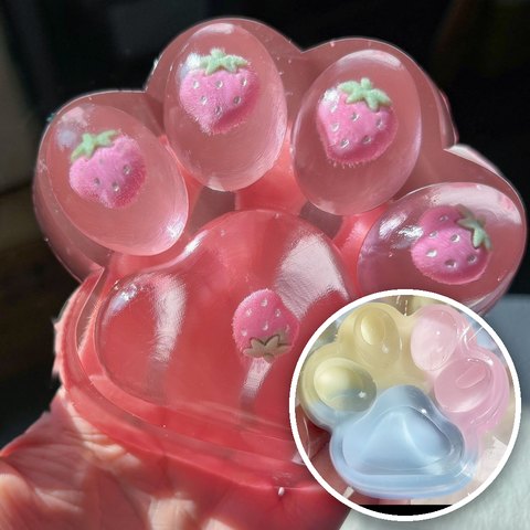 Cat paw squishies: big pink strawberry paw and small yellow, pink and blue paw